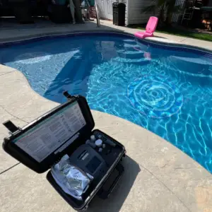 Sparkling clean backyard swimming pool maintained by Oak Island pool technicians