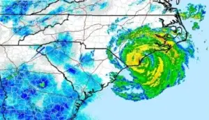A weather radar shows a hurricane near Oak Island, NC, with rain bands over Grey Shark Pool Services and the southeastern U.S.